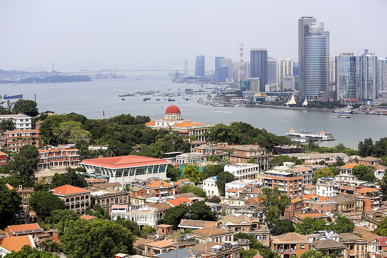 Red-roofed buildings and trees on Gulangyu, looking across the bay towards Xiamen